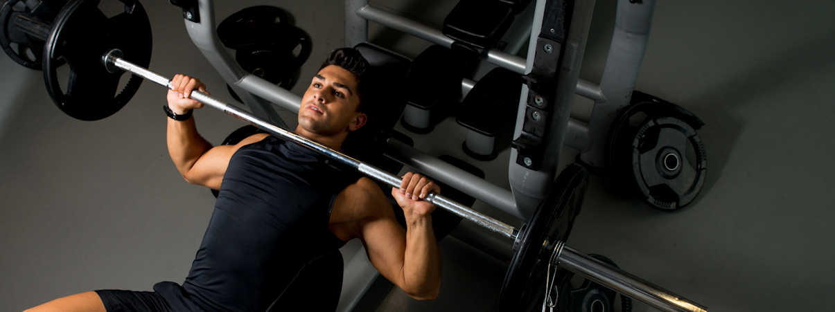 Man Exercising with Free Weights in Gym