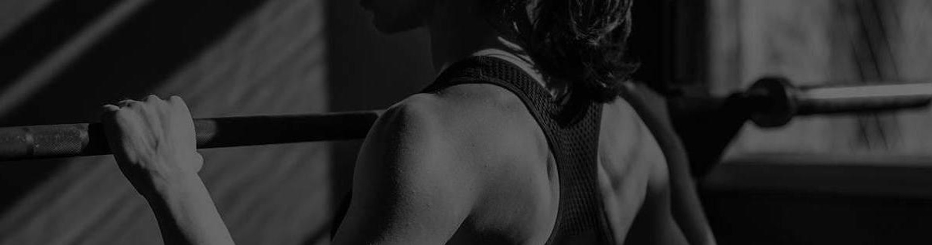 Woman Exercising on Commercial Workout Rack in Gym